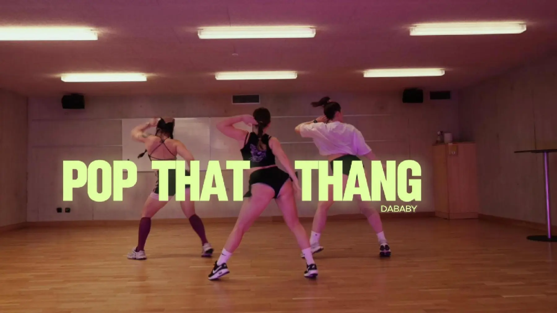 Dancers practising choreography together in a studio.