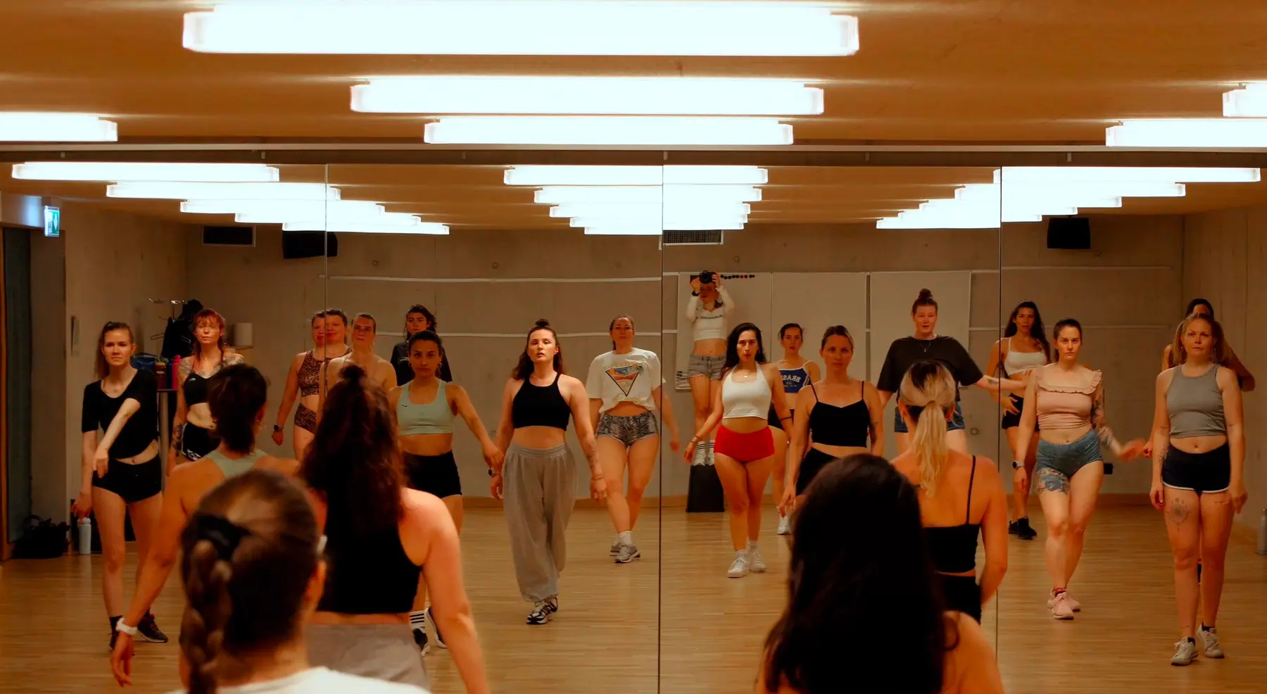 Advanced dancers moving together during a focused studio class.